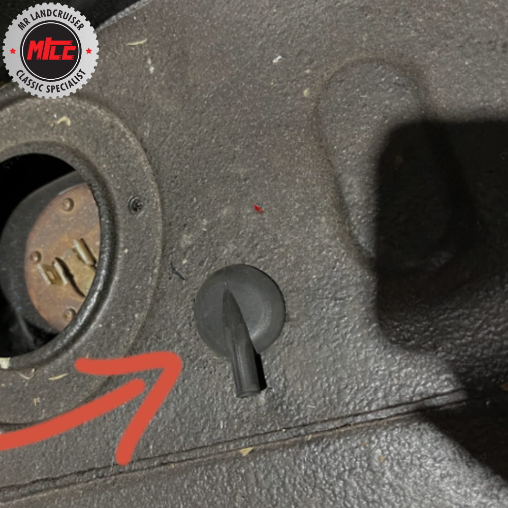 Close-up of a car's ignition switch with a red arrow pointing to it, branded with 'MCC Classic Specialists'.