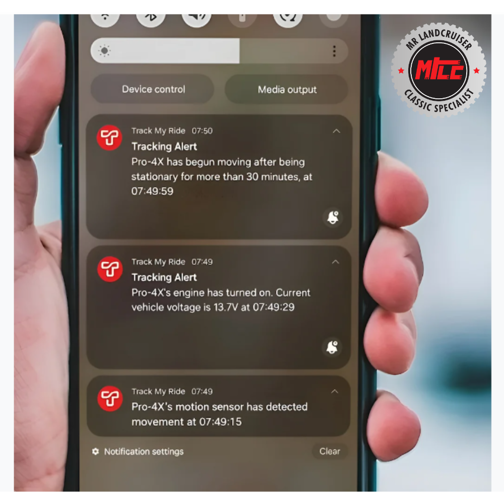 Phone screen displaying tracking alerts with a blurred background