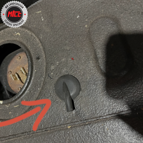 Close-up of a car's ignition switch with a red arrow pointing to it, branded with 'MCC Classic Specialists'.