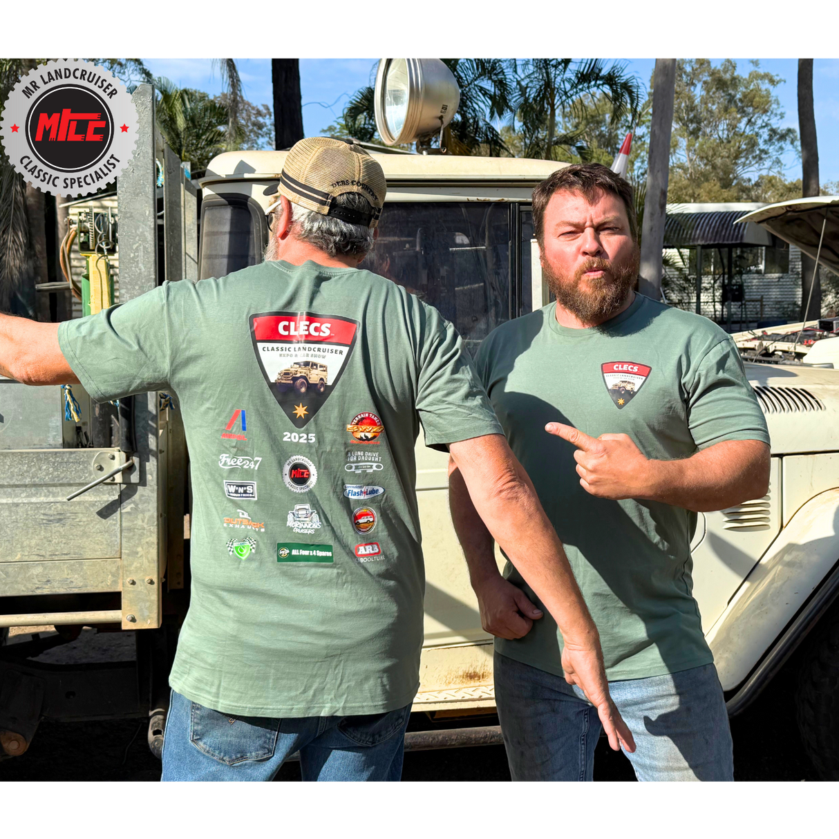 Two men wearing CLECS 2025 green t-shirts with various logos in front of a vehicle.