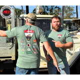 Two men wearing CLECS 2025 green t-shirts with various logos in front of a vehicle.
